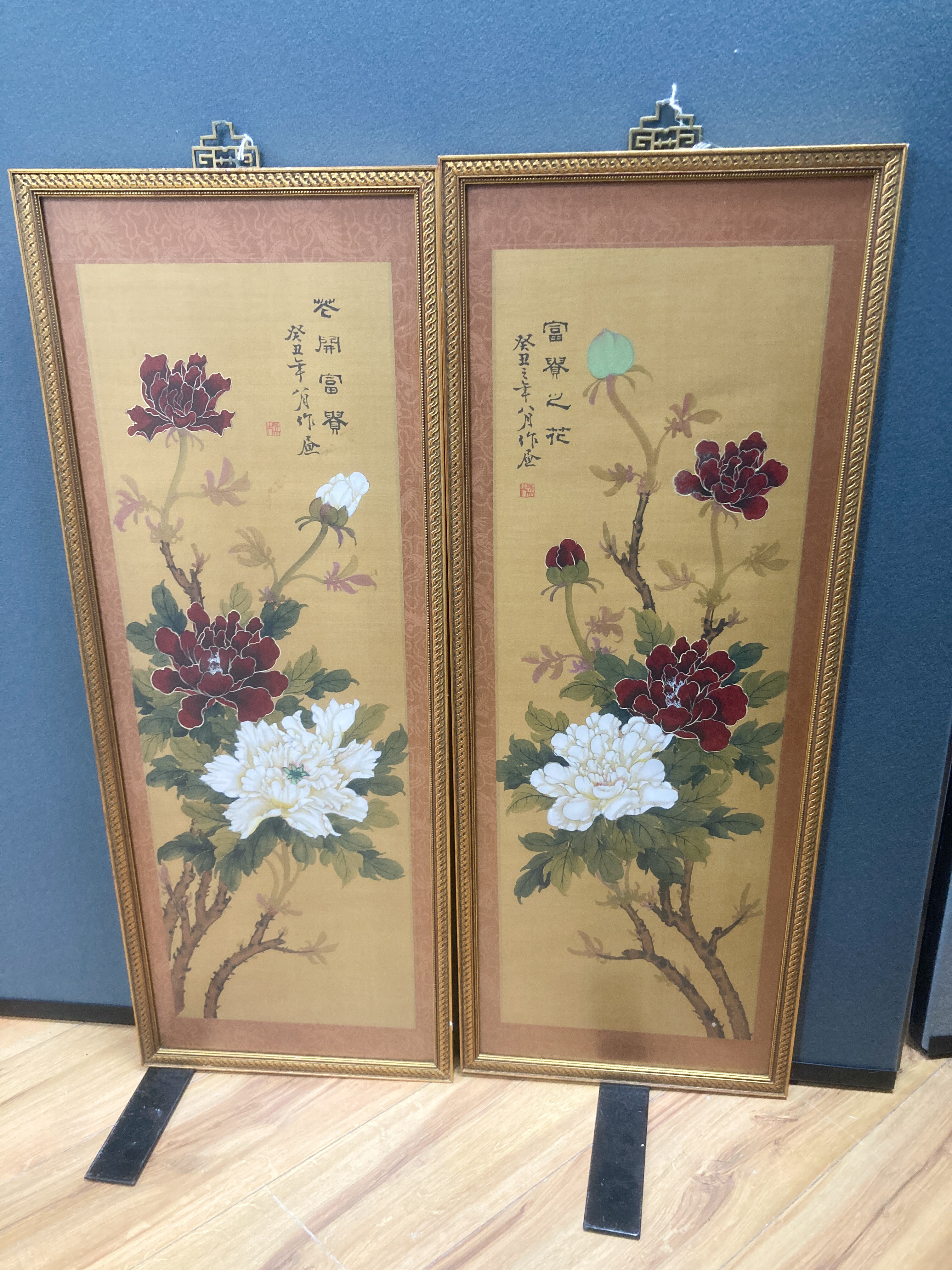 A pair of Chinese fabric panels decorated with chrysanthemums inscription and red sea, 74 x 25cm, framed